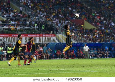 KUALA LUMPUR - AUGUST 10: Malaysia's M. Fadhli heads the ball in a match vs FC Barcelona at the Shah Alam Stadium on August 10, 2013 in Kuala Lumpur, Malaysia. Barcelona wins 3-1.