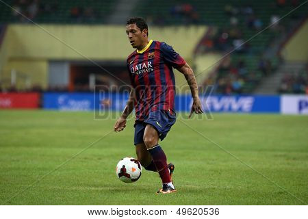 KUALA LUMPUR - AUGUST 10: FC Barcelona's Adriano (maroon/blue) dribbles the ball in a friendly match vs Malaysia at the Shah Alam Stadium on August 10, 2013 in Malaysia. Barcelona wins 3-1.