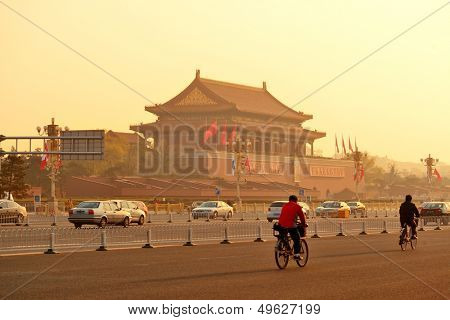 BEIJING, CHINA - APR 6: Tiananmen sunrise with street on April 6, 2013 in Beijing, China. Tiananmen is a famous monument in Beijing and serves as a national symbol.