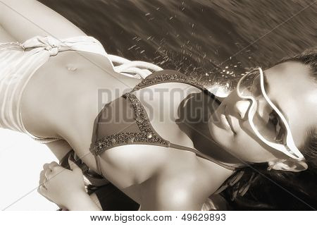 beautiful girl on speed boat - sepia toned picture