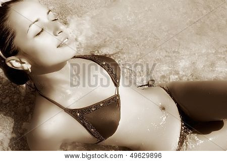 beautiful girl on beach - sepia toned picture