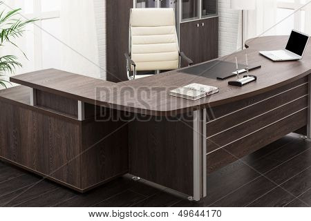 laptop on a desk in a modern office