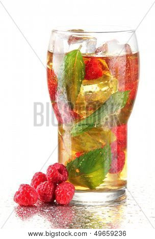 Iced tea with raspberries and mint isolated on white