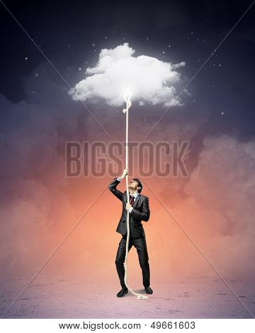 Image of businessman climbing rope attached to cloud