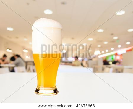 glass of fresh draft unfiltered beer on table in cafe