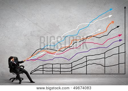 Image of young businessman pulling graph. Chart growth concept