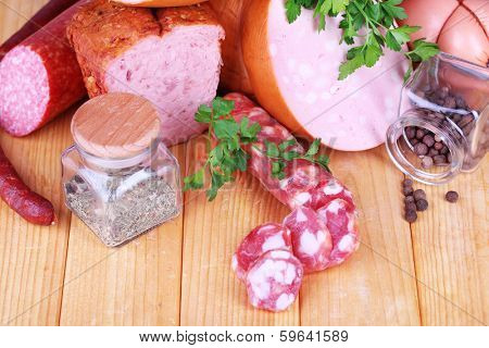 Lot of different sausages on wooden table close-up