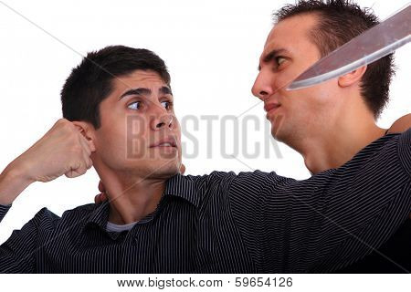 Man defending himself against a knife attack isolated on white