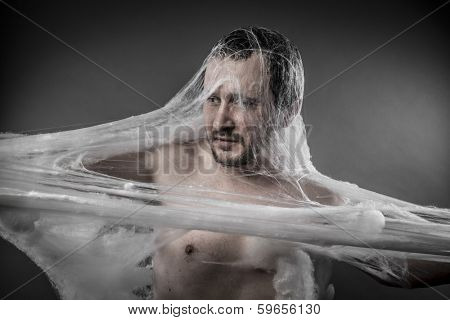 Trap.man tangled in huge white spider web