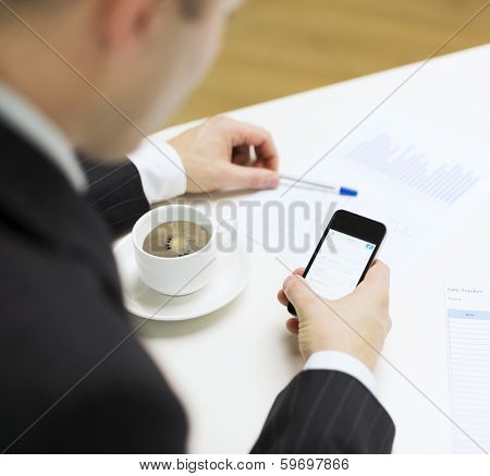 business, technology and interent concept - businessman with smartphone reading news