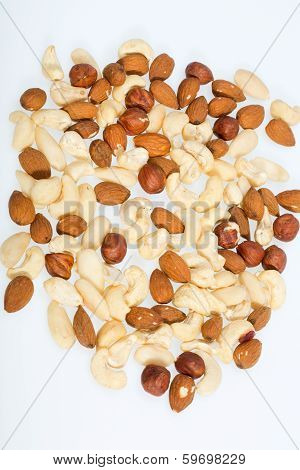 mixed nuts - hazelnuts walnuts cashews pine nuts isolated on white background