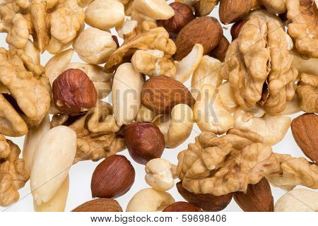 background of mixed nuts - hazelnuts walnuts cashews pine nuts