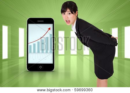Surpised businesswoman bending against bright green room with windows