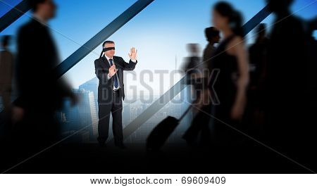 Mature businessman in a blindfold against room with large window looking on city