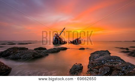 Fishing boat beached with sunset view