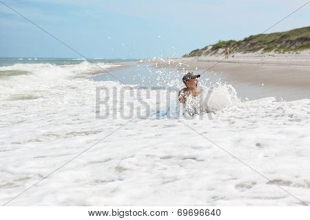 child boy and sea wave splash