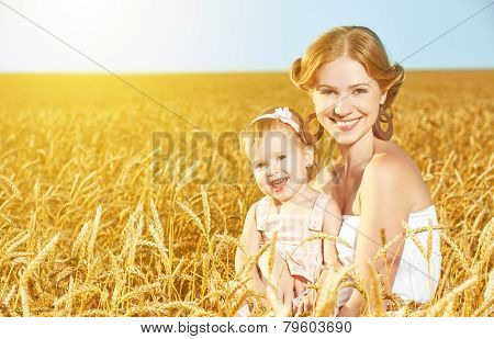 Happy Family In Summer Nature. Mother And Baby Daughter In The Wheat Field