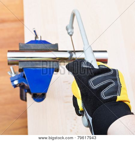 Sanitary Technician Saws Metal Trap Pipe