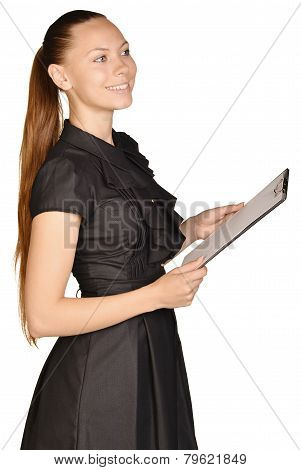 Beautiful girl holding a clip board in hand and looking at the front.
