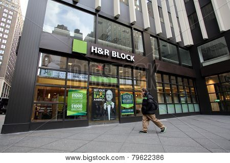 NEW YORK CITY - MONDAY, DEC. 29, 2014: Pedestrians walk past an office of H&R Block. H&R Block is a tax preparation company in the United States