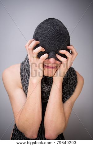 A shirtless man with scarf and hat