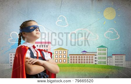 Cute girl of school age wearing super hero costume