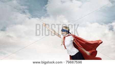 Young confident woman in super hero costume