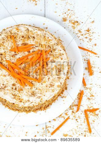 Gourmet homemade sponge cake with carrot slices and walnut crumbs