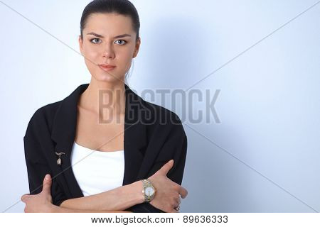 A young woman standing, isolated on graybackground