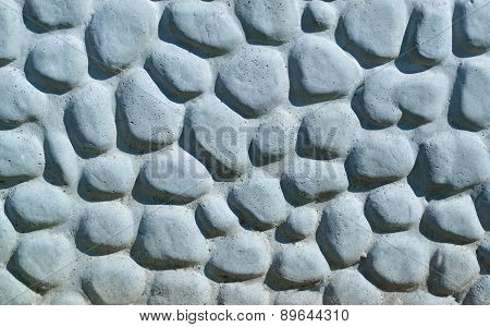 Background Made Of A Closeup Of A Wall With Pebbles