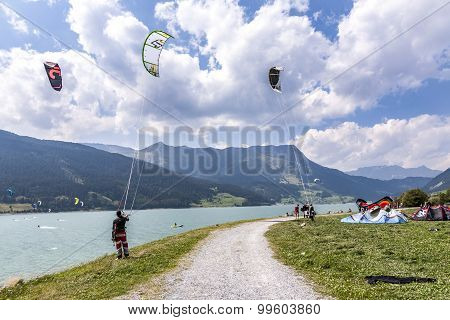 People Enjoy Windsurfing At Lake Levico In Latsch