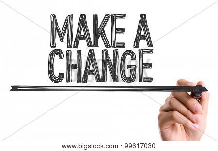 Hand with marker writing the word Make a Change