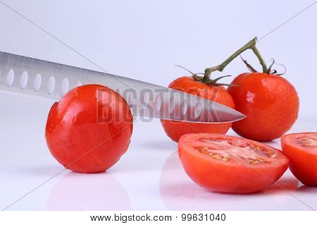 Tomatoe With Iron Knife Isolated On White Background.