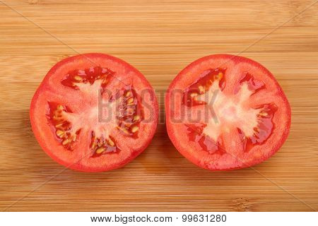 Top View Of Half Tomato On Wooden Background. Sliced Tomato