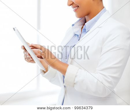 office, business, technology and internet concept - businesswoman with tablet pc in office