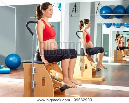 pregnant woman pilates leg pumps exercise on wunda chair