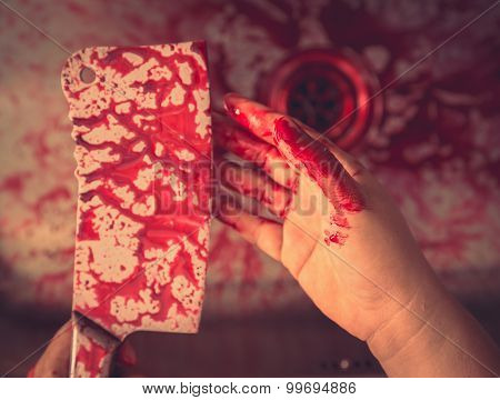 Hand hold bloody knife in a steel shell for halloween ( Filtered image processed vintage effect. )