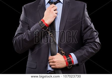 man in a business suit with leather bound. handcuffs. sex Toys