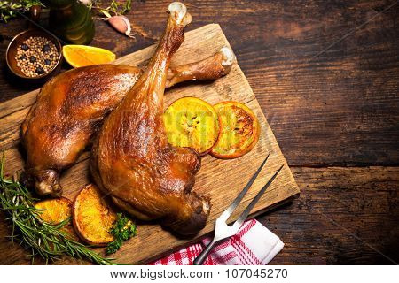Roasted goose legs with oranges and spices. Cooking at Christmas time
