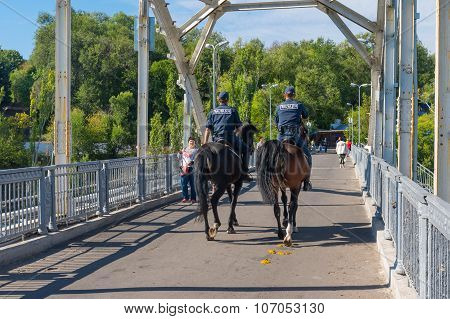 Local police(called miliciya) doing hoeses beat on a bridge over Dnepr river