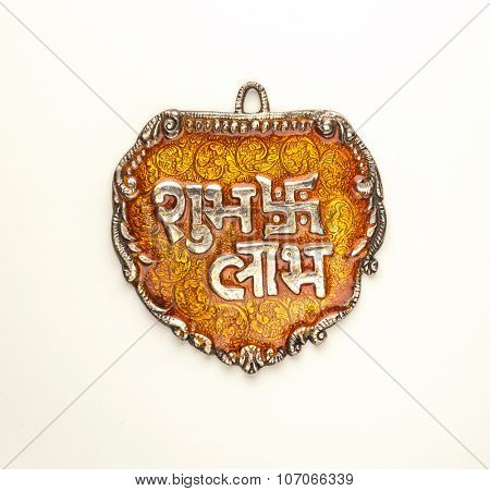 'Shubh Labh' - An auspicious Indian slogan. Translation : 'Auspicious' and 'Profit'. Isolated metal plaque.