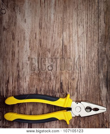 handtools  pliers on wooden doard