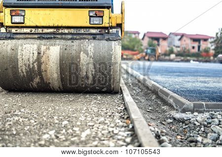 Vibration Roller Compactor At Road Construction And Reparing Asphalt Pavement. Compactor Working On