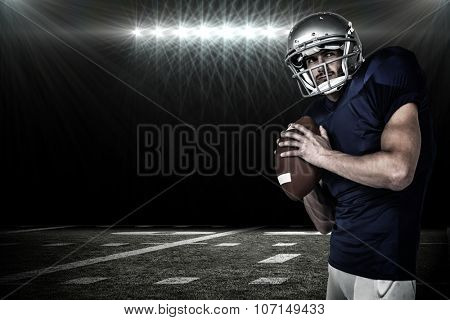 Sports manto throwing the ball against spotlight