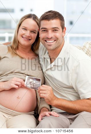 Gurur gelecekteki anne ve baba bir Echography kameraya gösteren