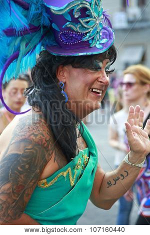 Naples, Italy, July 11 2015: A Partecipant With Blue Ornated Hat In The Naples Gay Pride Parade. Tho