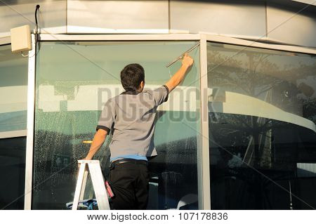 Housekeeper Window Cleaner Working Outside Building