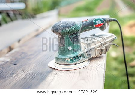 Carpenter Using Electric Sander