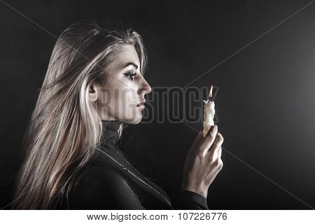 Young Woman Holding A Candle In A Smoke