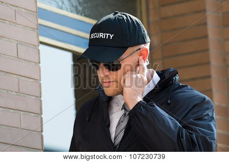 Young Security Guard Standing In Front Of The Entrance